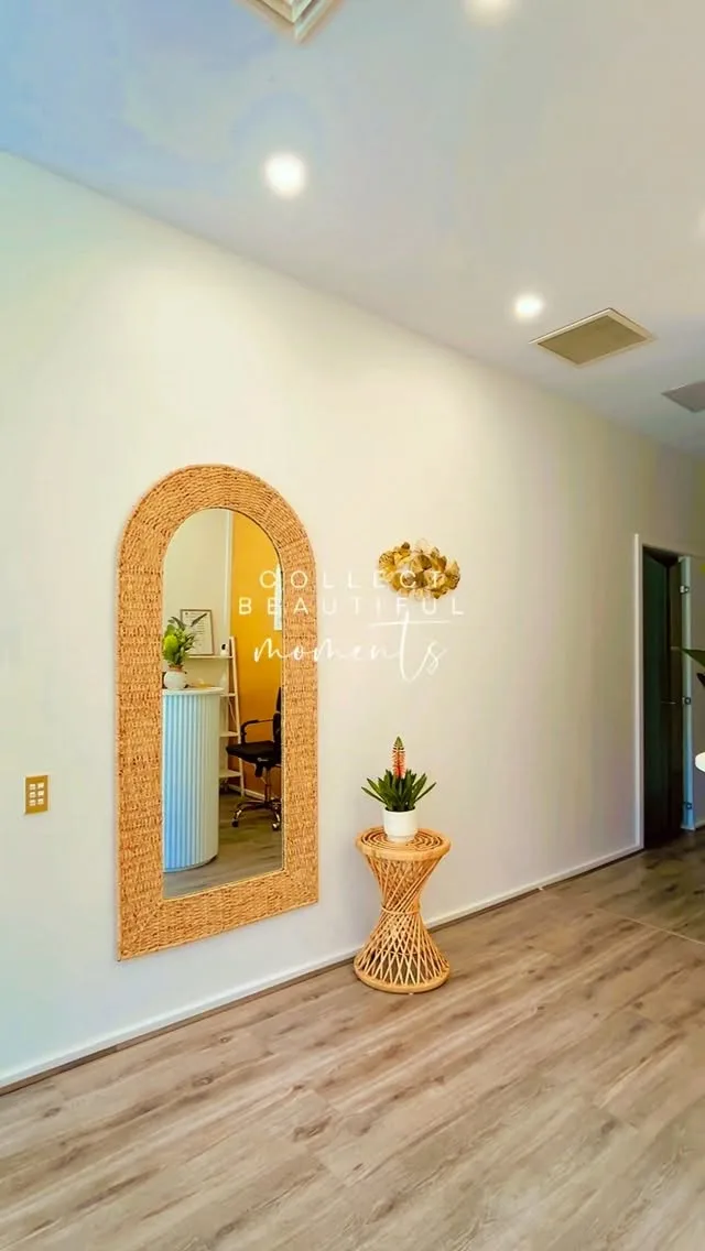 ANDA Camberwell reception nook — arched woven-rattan mirror, potted plant and rattan side table